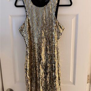 BÉBÉ Elegant Gold and Black Sequin Mini Dress with cold-shoulder cutouts. SL